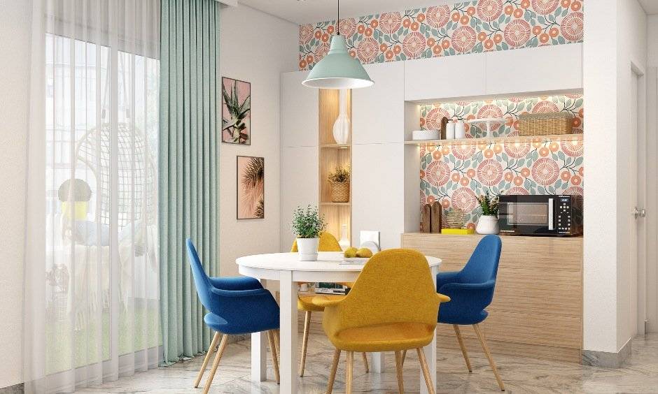 2bhk house interior design with compact round dining table and four upholstered chairs
