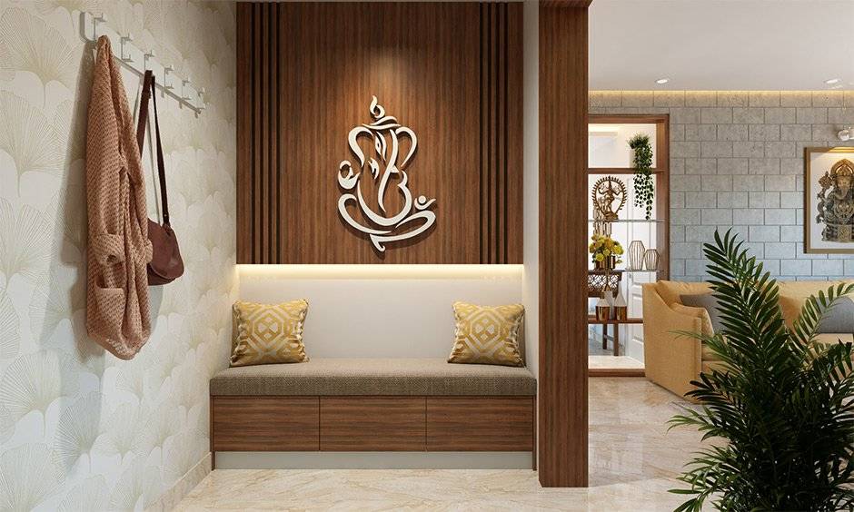 A guide on a small entryway design with cosy seating and motifs of Lord Ganesh on the wall brings in a tranquil vibe